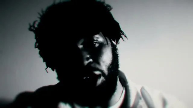 Knockin' At My Door cover: a bearded man with locs, close up in black and white