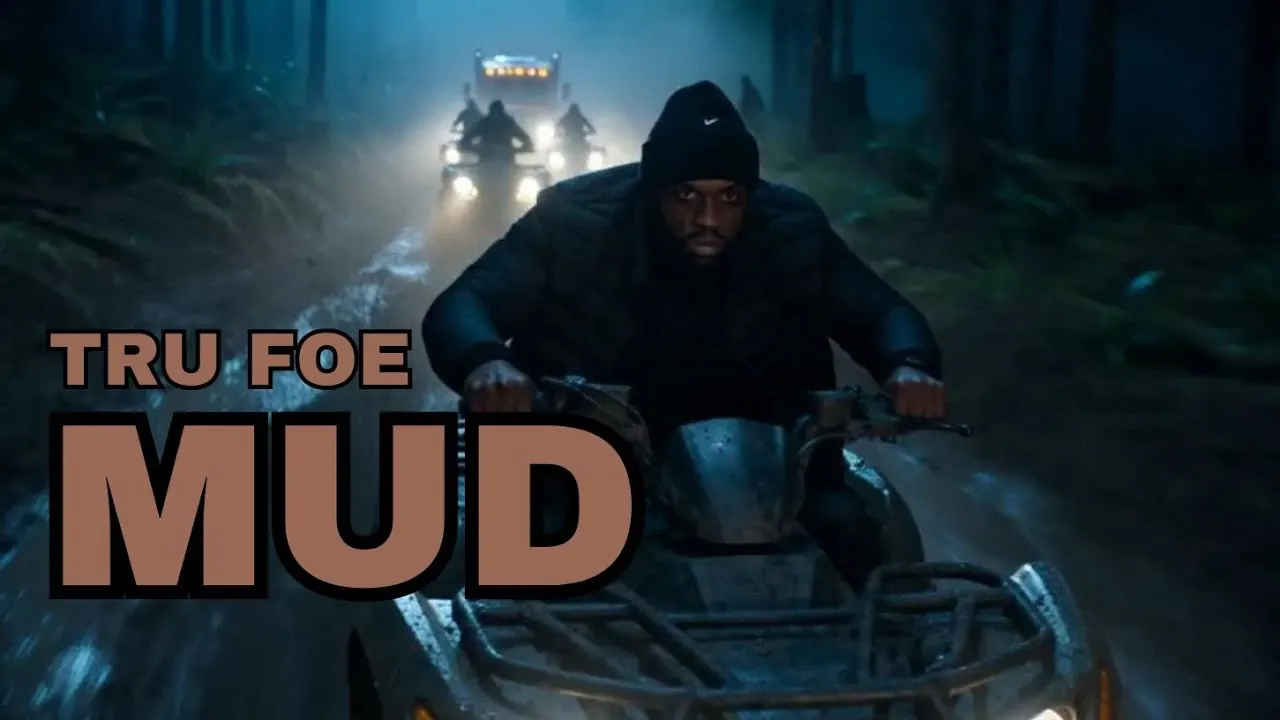 Tru Foe on a four-wheeler in the woods at night, his crew's headlights behind him, with the word Mud